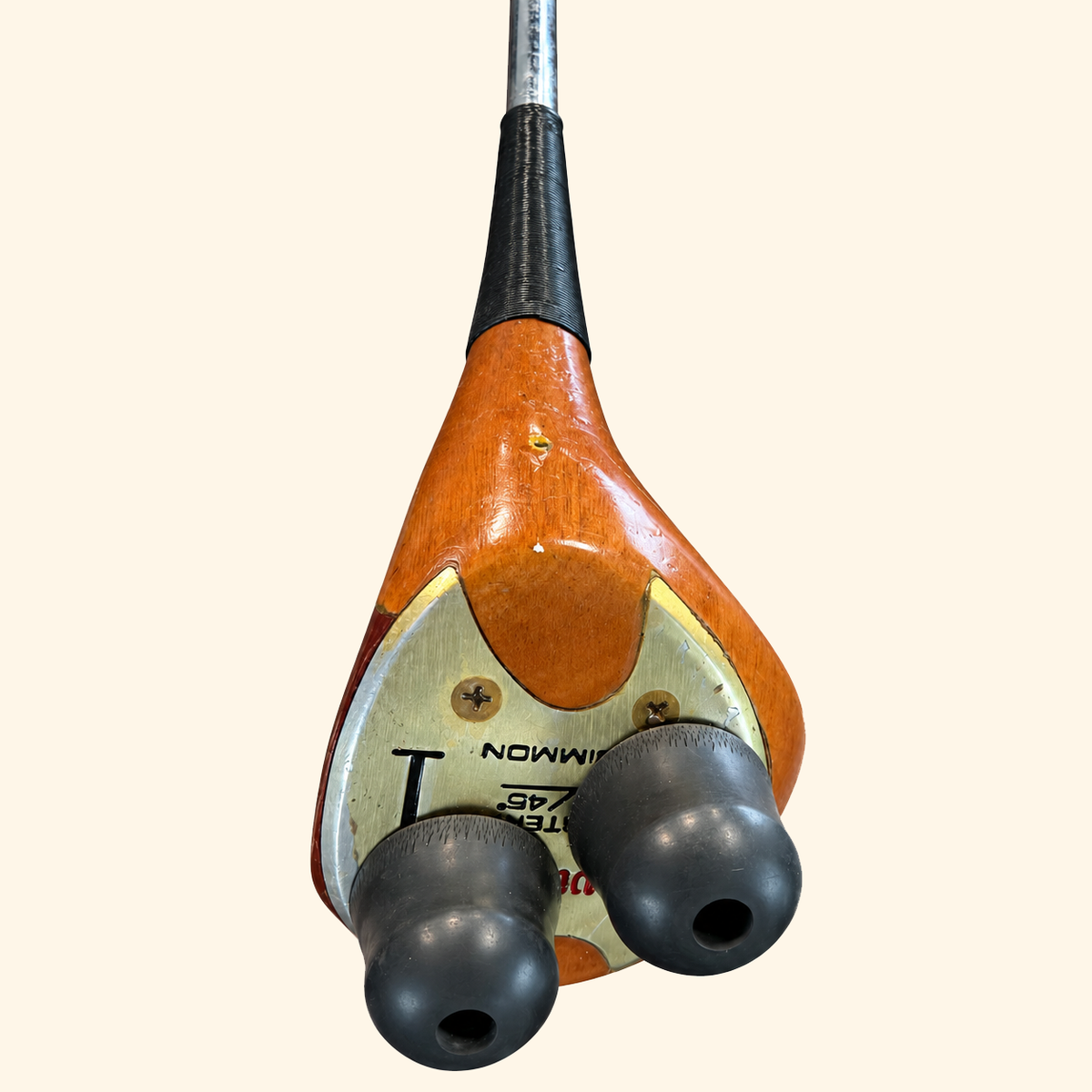 The Wilson Heritage club head sole and rubber feet on a cream background