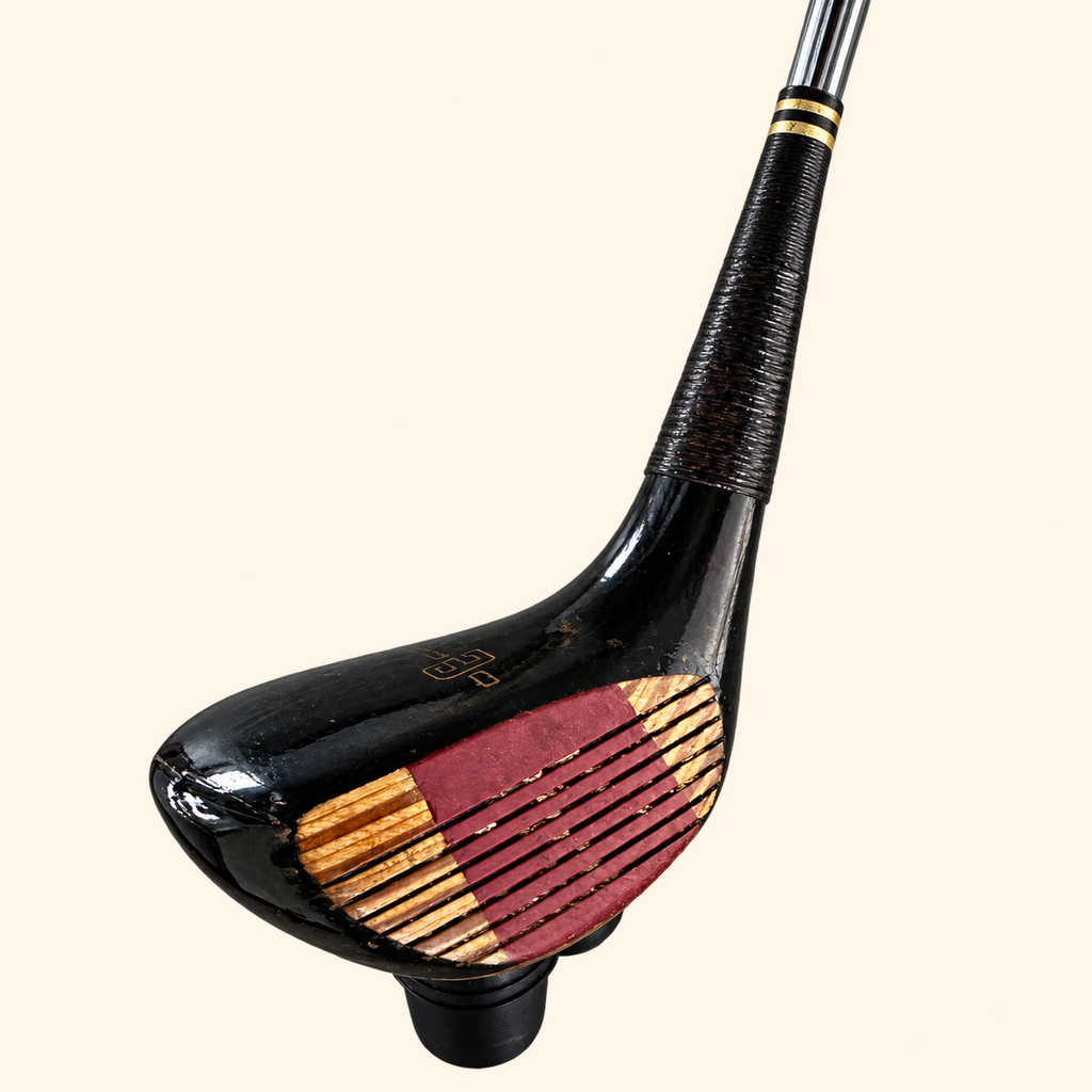 The Fairway Flame black club head with red face insert on a cream background