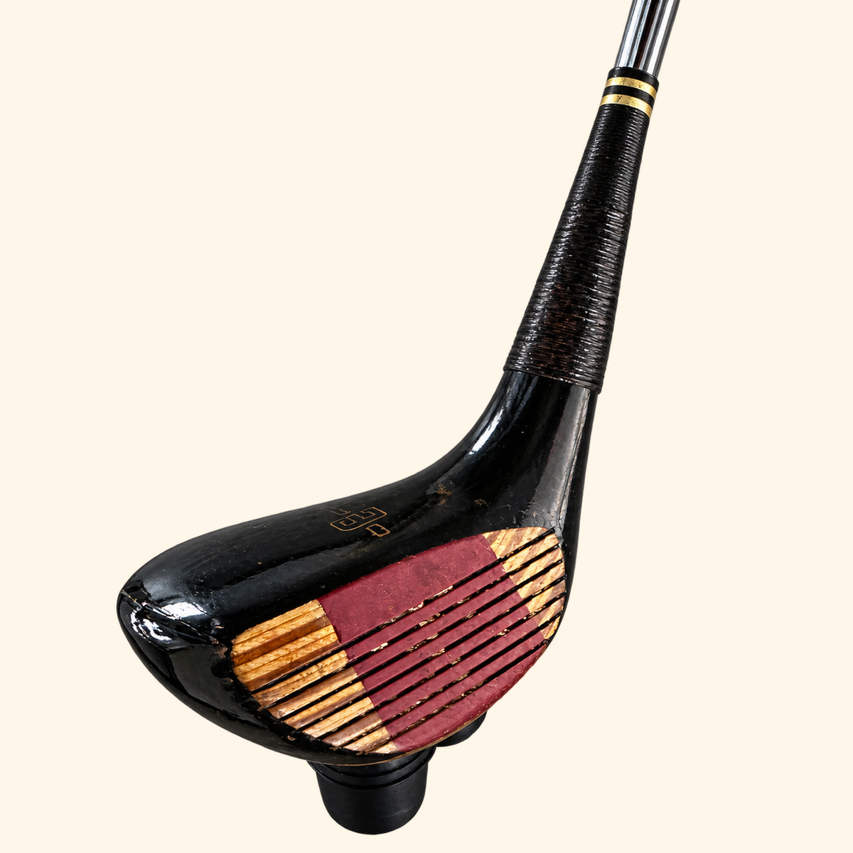 The Fairway Flame black club head with red face insert on a cream background